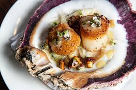 Atlas The Restaurant signature dishes Maine Diver Scallops, Pork Chop, Duck Breast, Turmeric Cheesecake